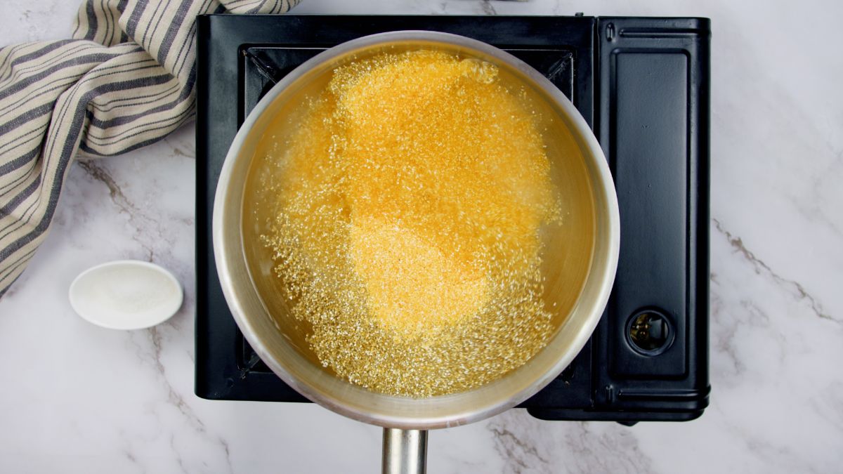 grits in water in pot on hot plate