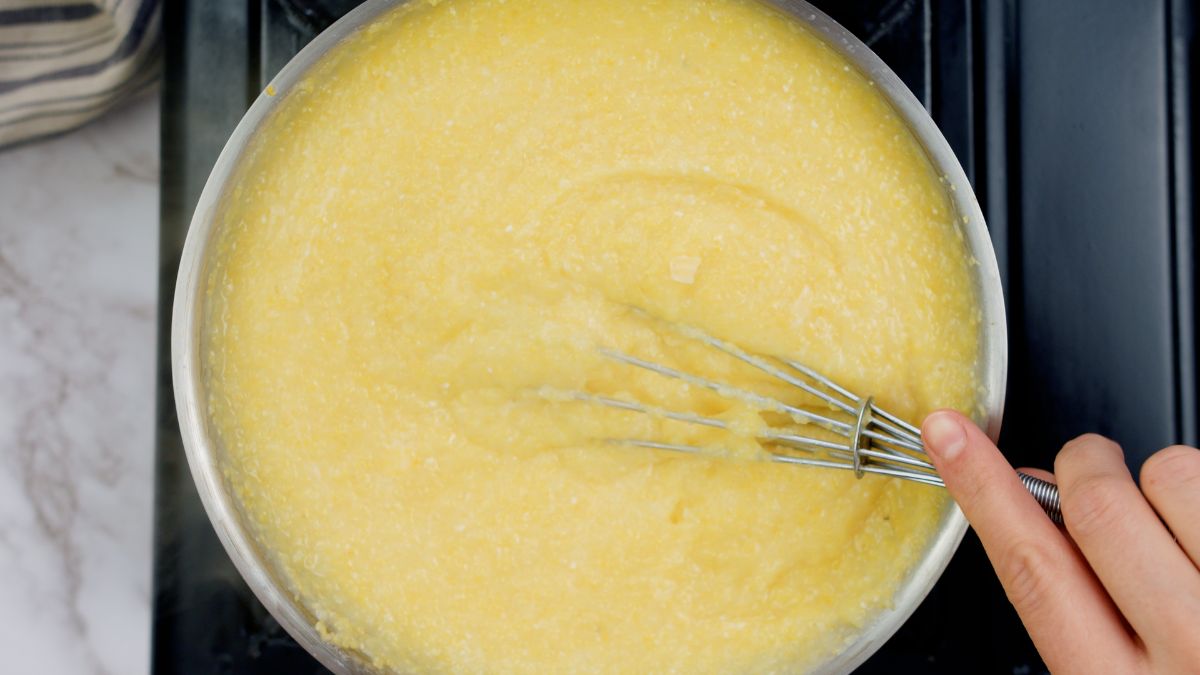 whisk in pot of grits