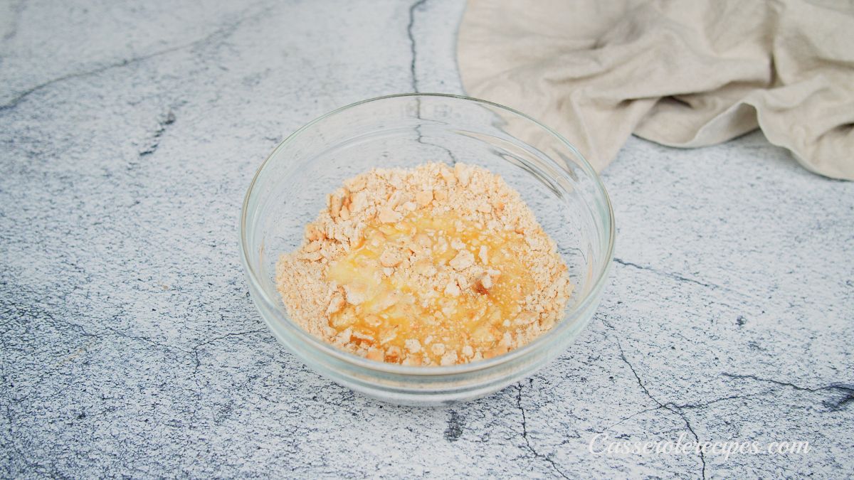 crackers and cheese crumbs mixed in small glass bowl