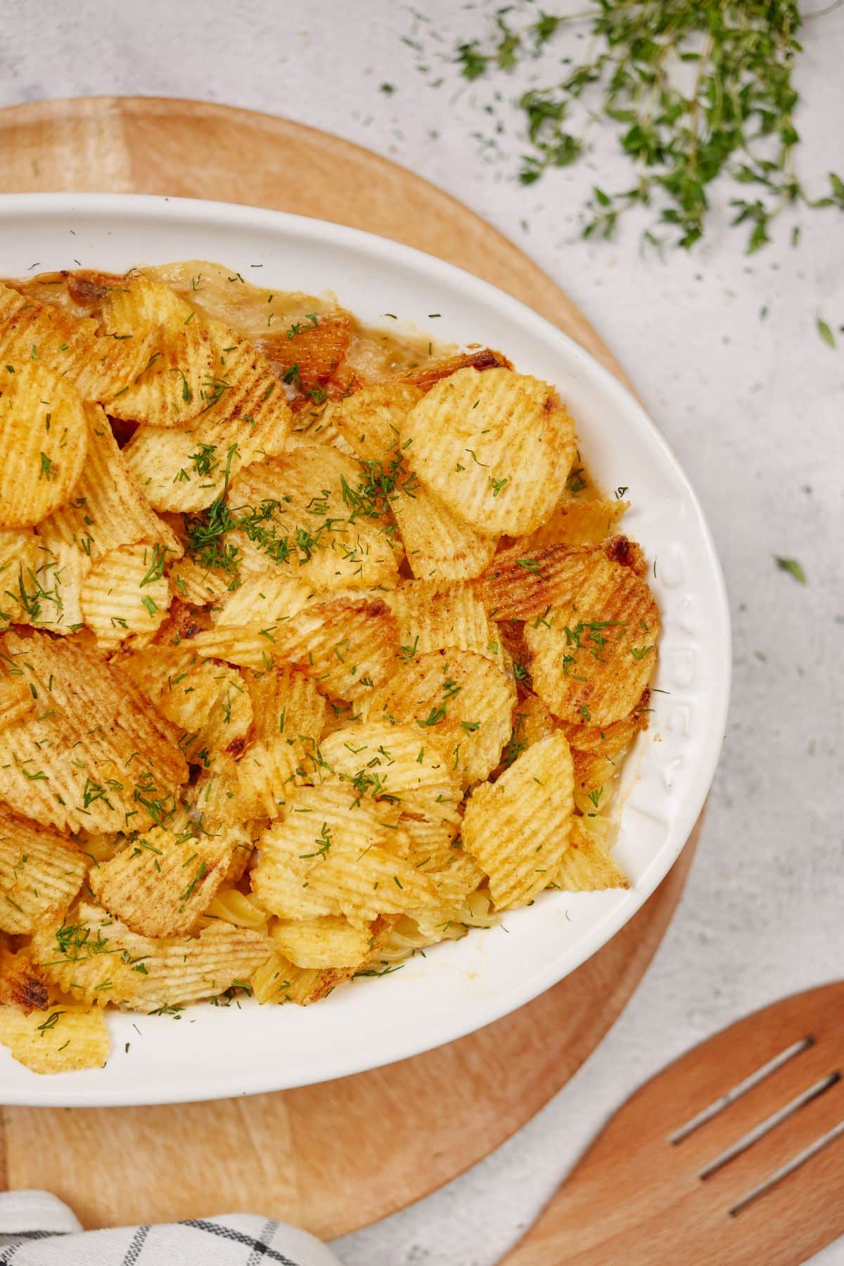 wavy chips on top of casserole in white baking dish
