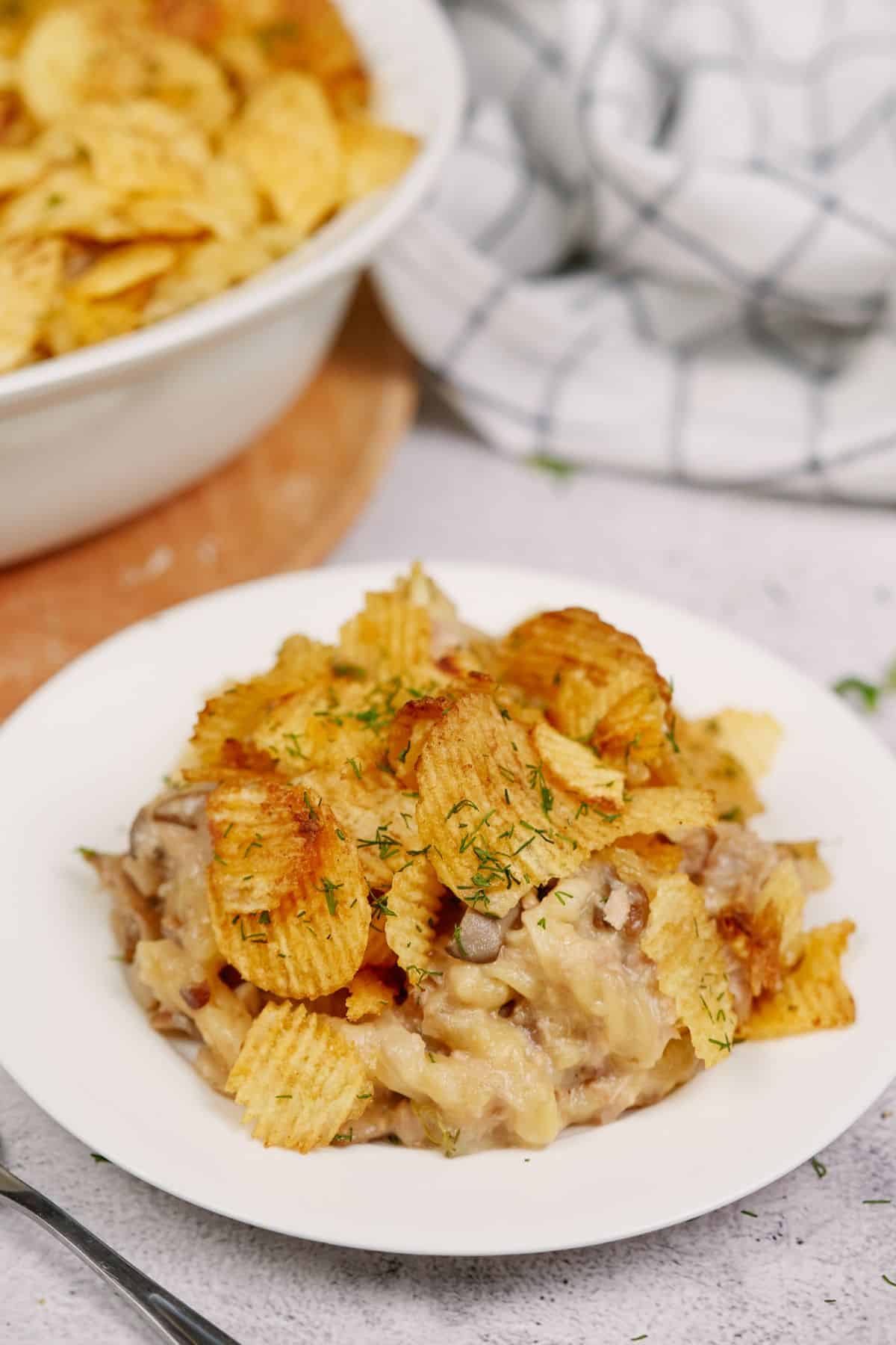 white plate of tuna noodle casserole with potato chips on top