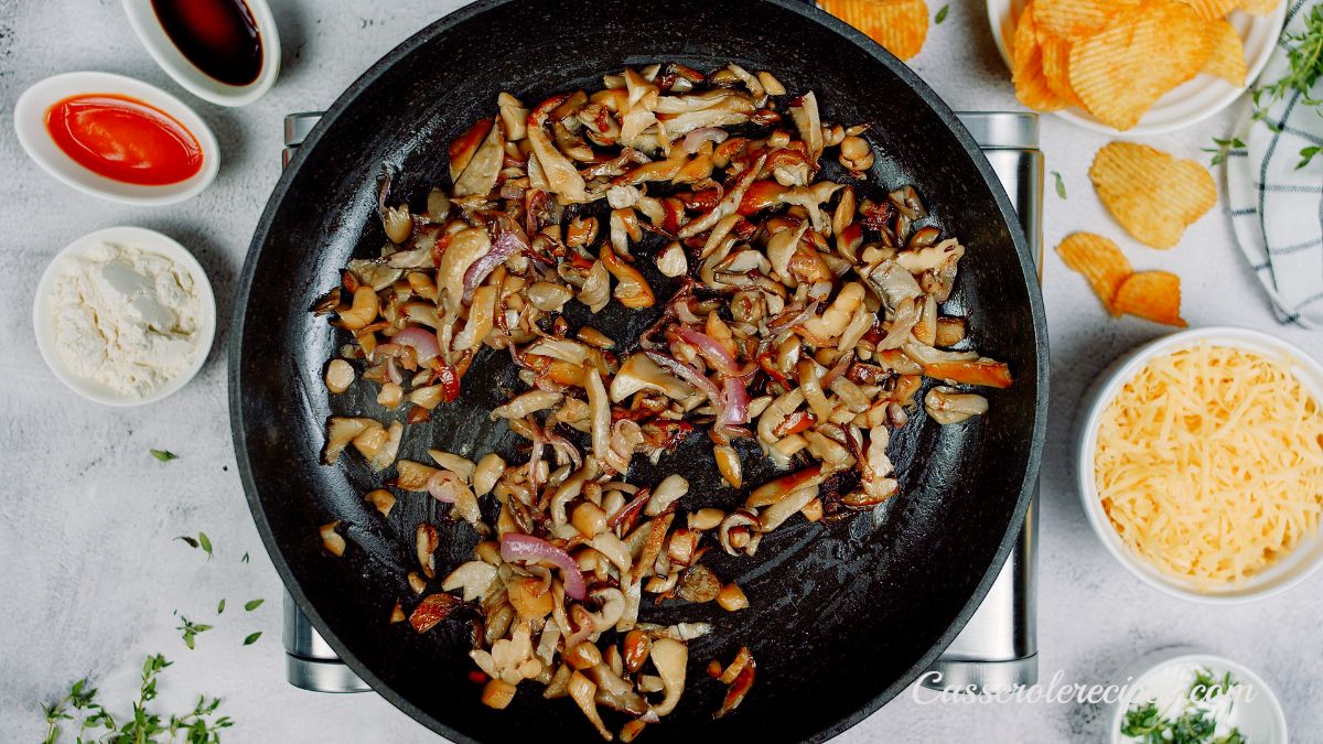 onions and mushrooms in black skillet