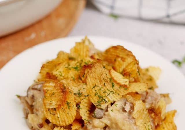 white plate of tuna noodle casserole with potato chips on top