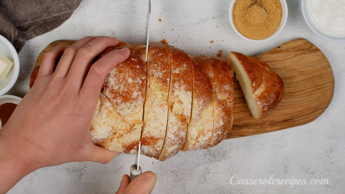 knife slicing brioche bread on cutting board