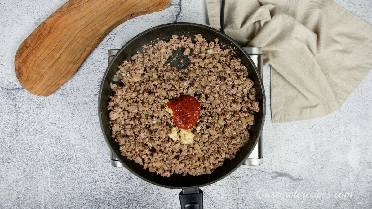 ground beef in skillet with spices on top