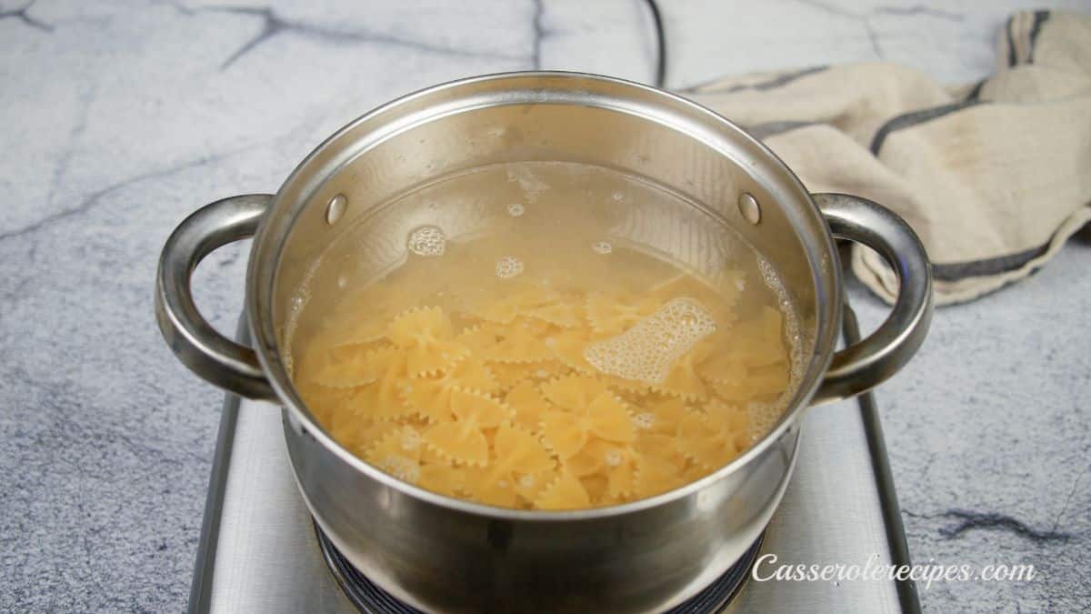 pasta being cooked in stainless steel stockpot on hot plate