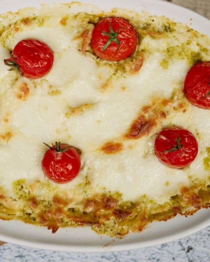 baked pesto pasta casserole in oval white baking dish