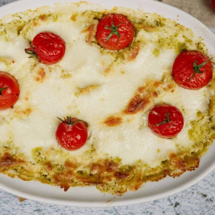 baked pesto pasta casserole in oval white baking dish