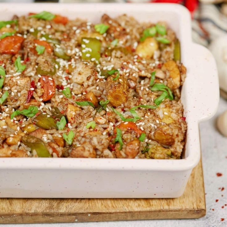 chicken and rice with vegetables in baking dish