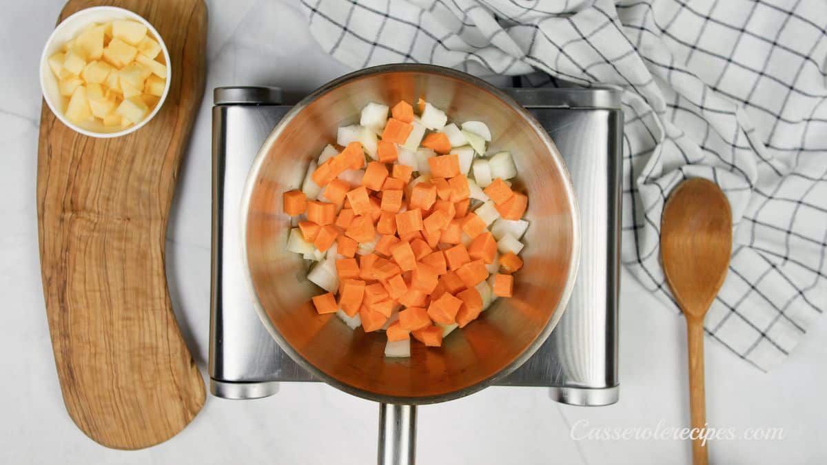 potatoes and carrots in stainless steel skillet