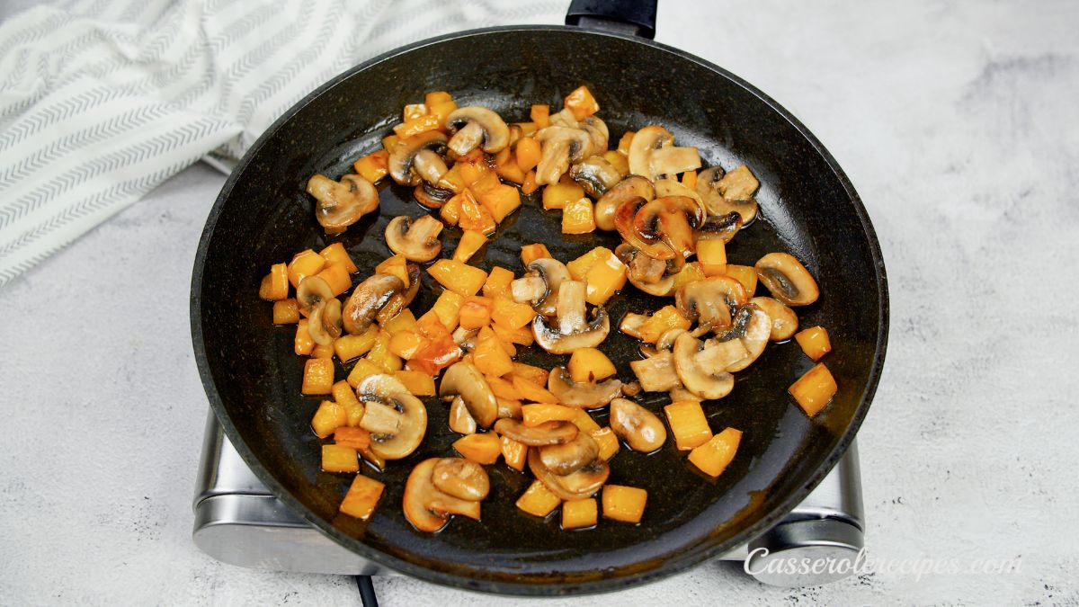 mushrooms being cooked in skillet on hot plate