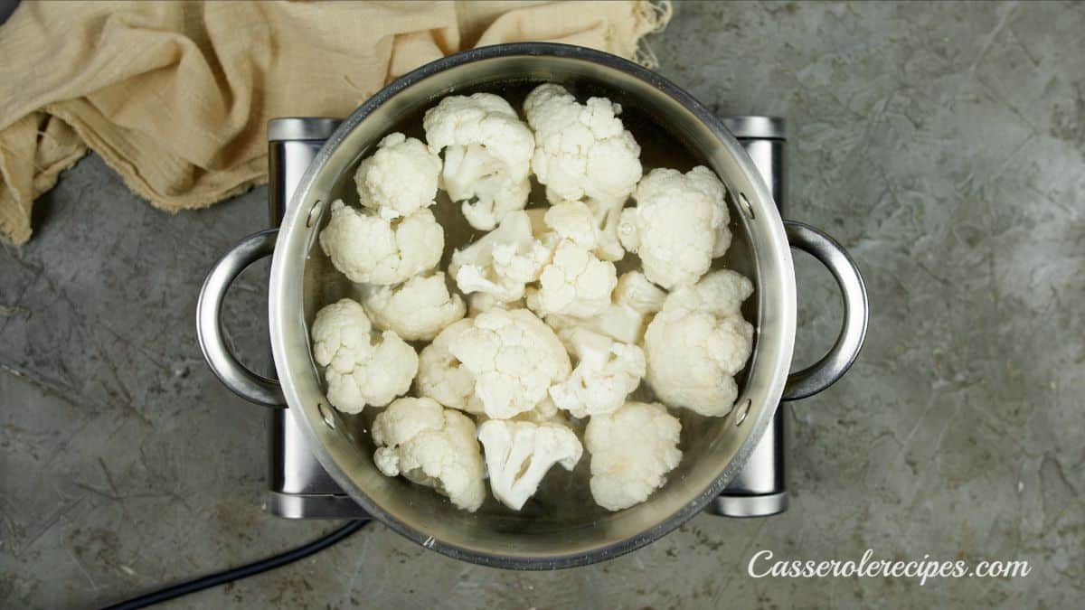 cauliflower being cooked in stockpot