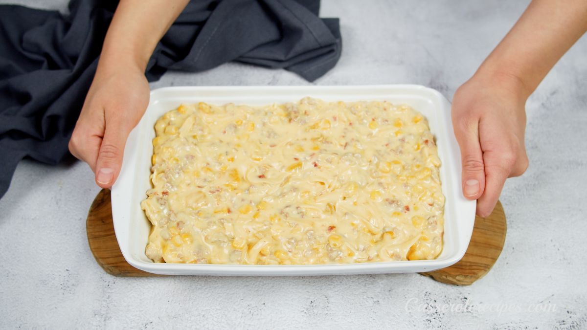 cheese on top of casserole in white baking dish