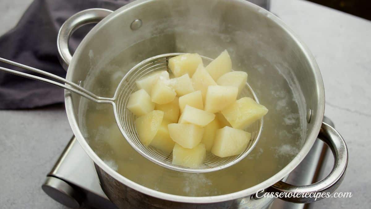 strainer holding potatoes above pot of water
