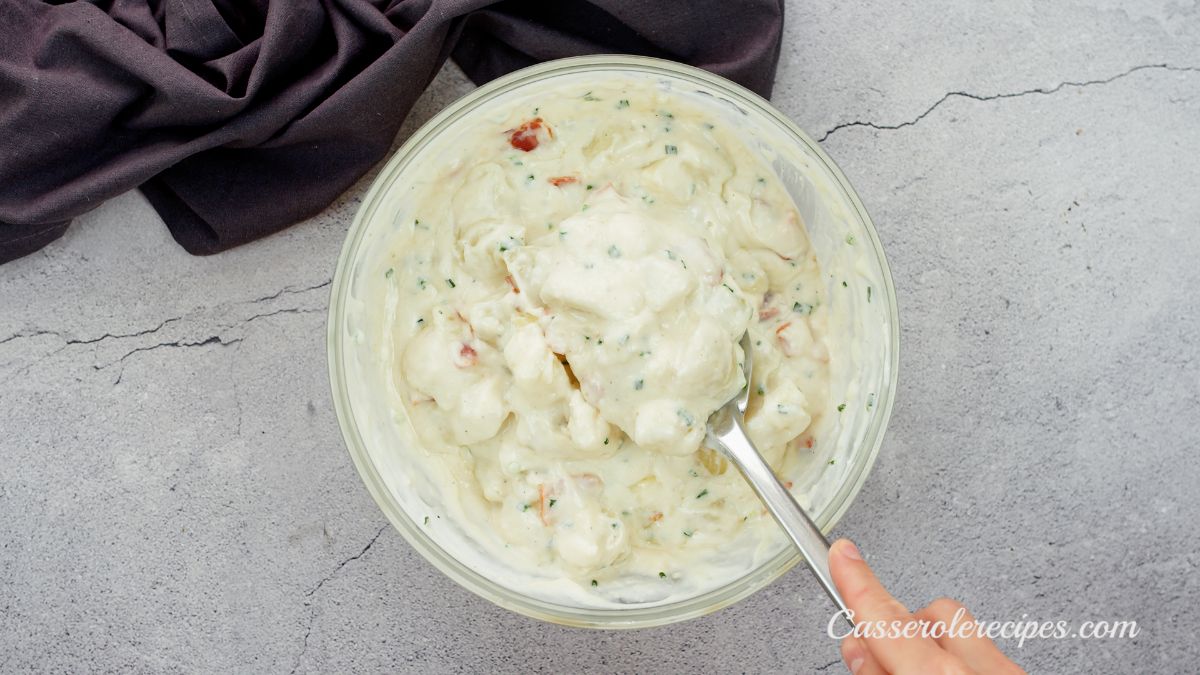 spoon in bowl of creamy potato sauce