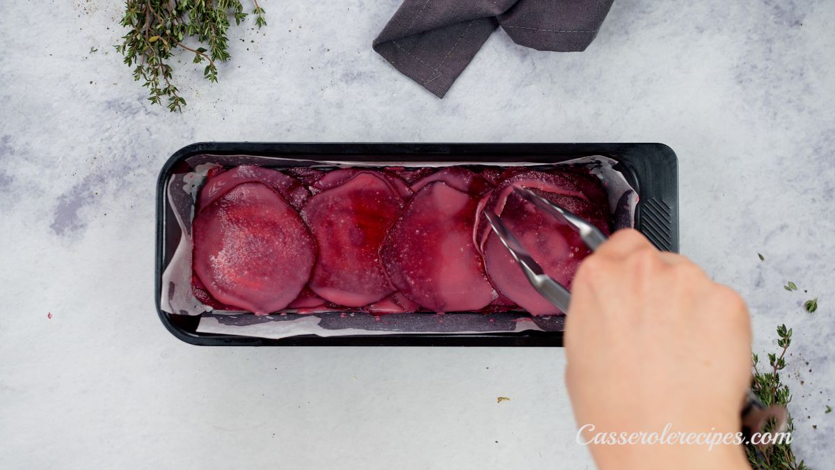 beets being layered in loaf baking dish
