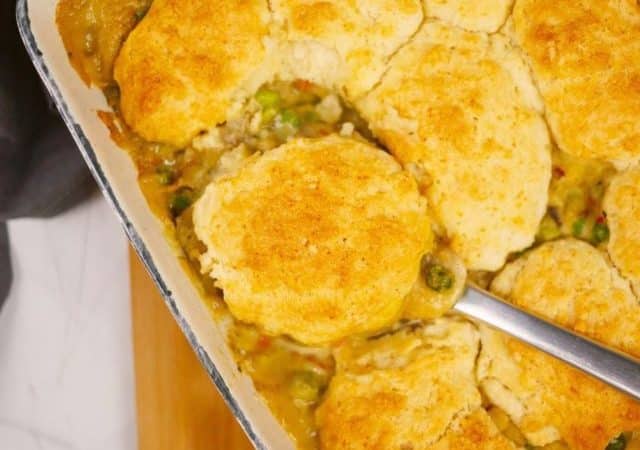 spoon of pot pie held above baking dish