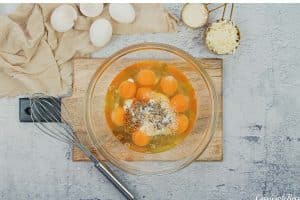 eggs and other ingredients being combined to make Crustless Quiche with Broccoli and Cauliflower
