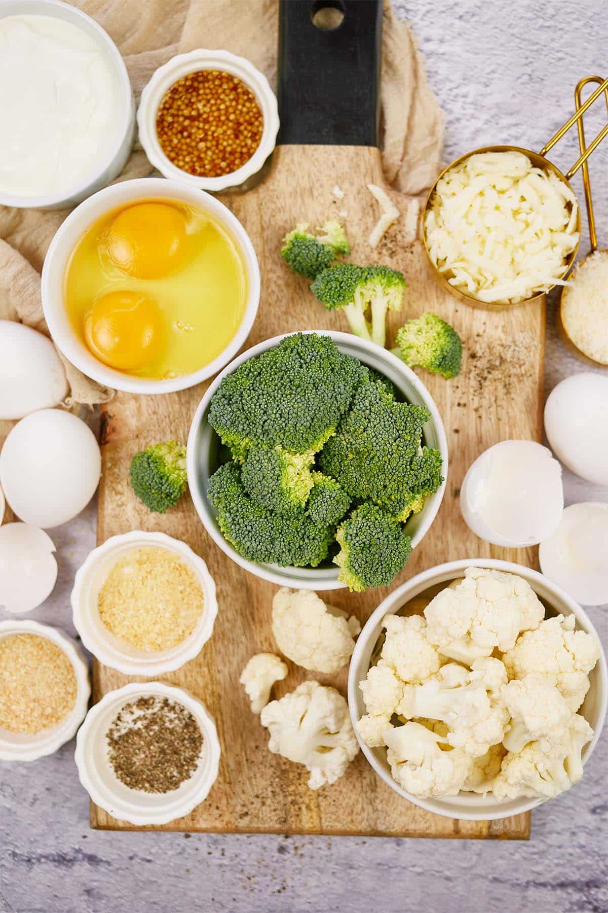 ingredients to make Crustless Quiche with Broccoli and Cauliflower laid out on a table
