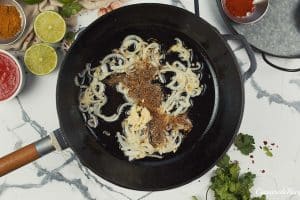 onions and spices being combined to sautee them to make North Indian Baked Eggs