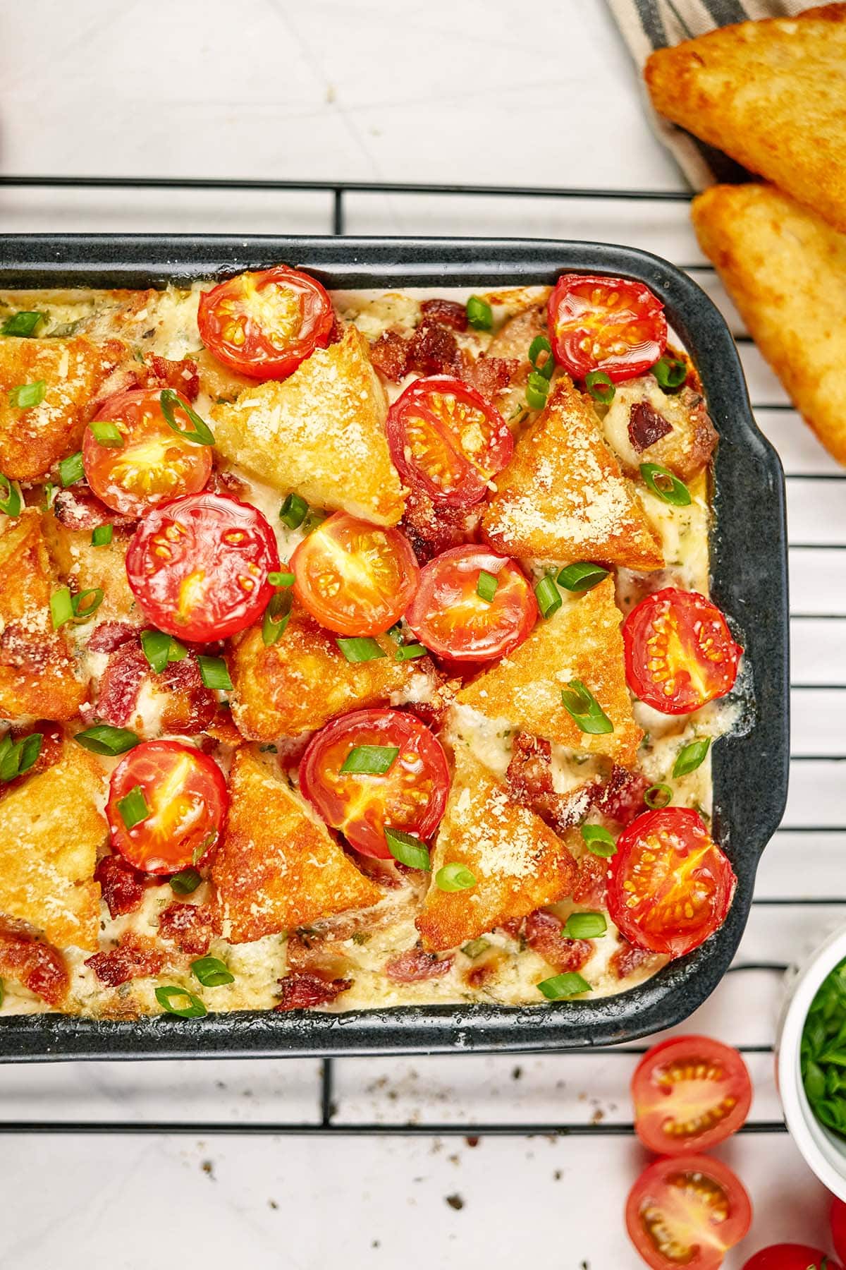 alfredo bacon tot casserole in a baking dish ready to serve