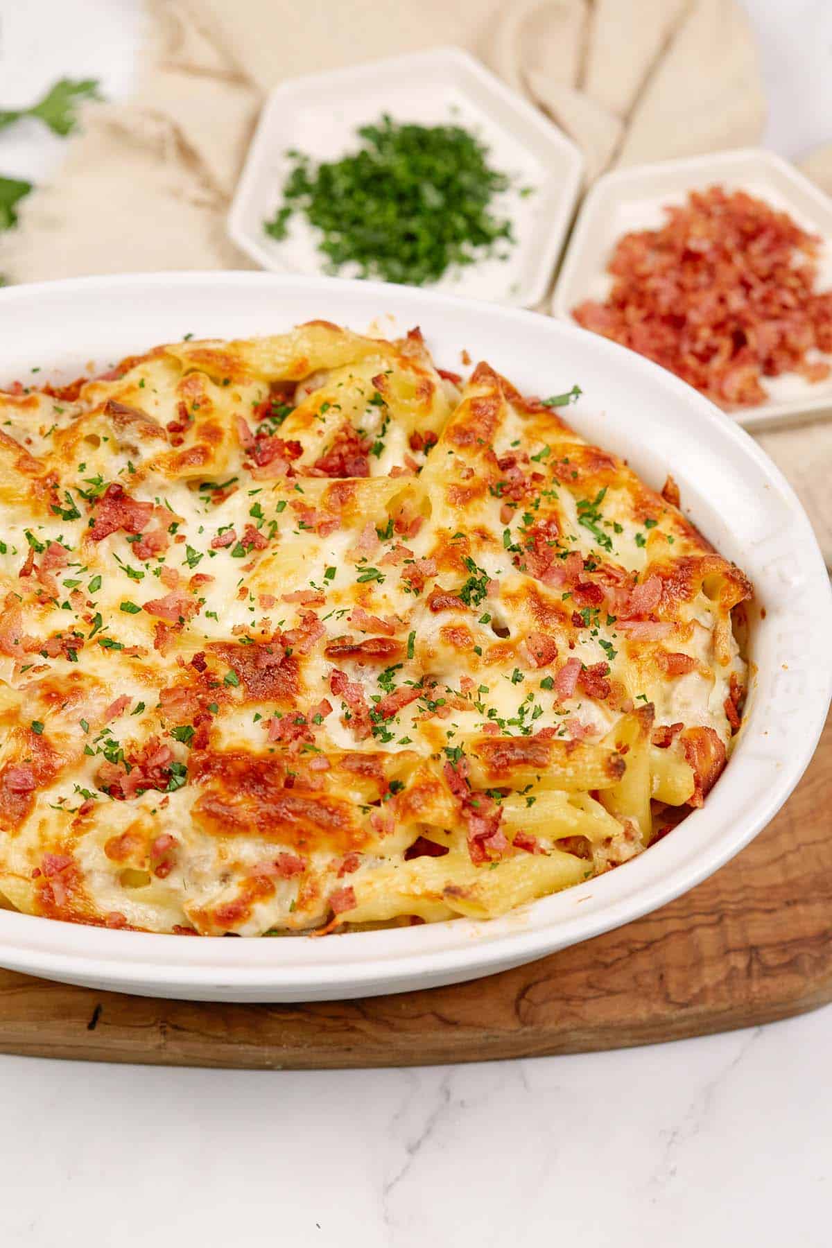 baking dish of chicken and bacon casserole on a table ready to serve