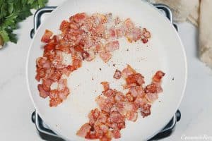 sautéing ingredients to make chicken and bacon casserole