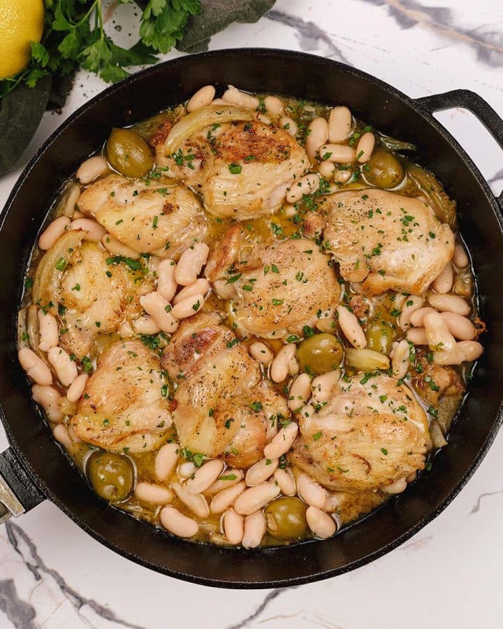 overhead view of a pan full of Chicken and Bean Summer Casserole with olives
