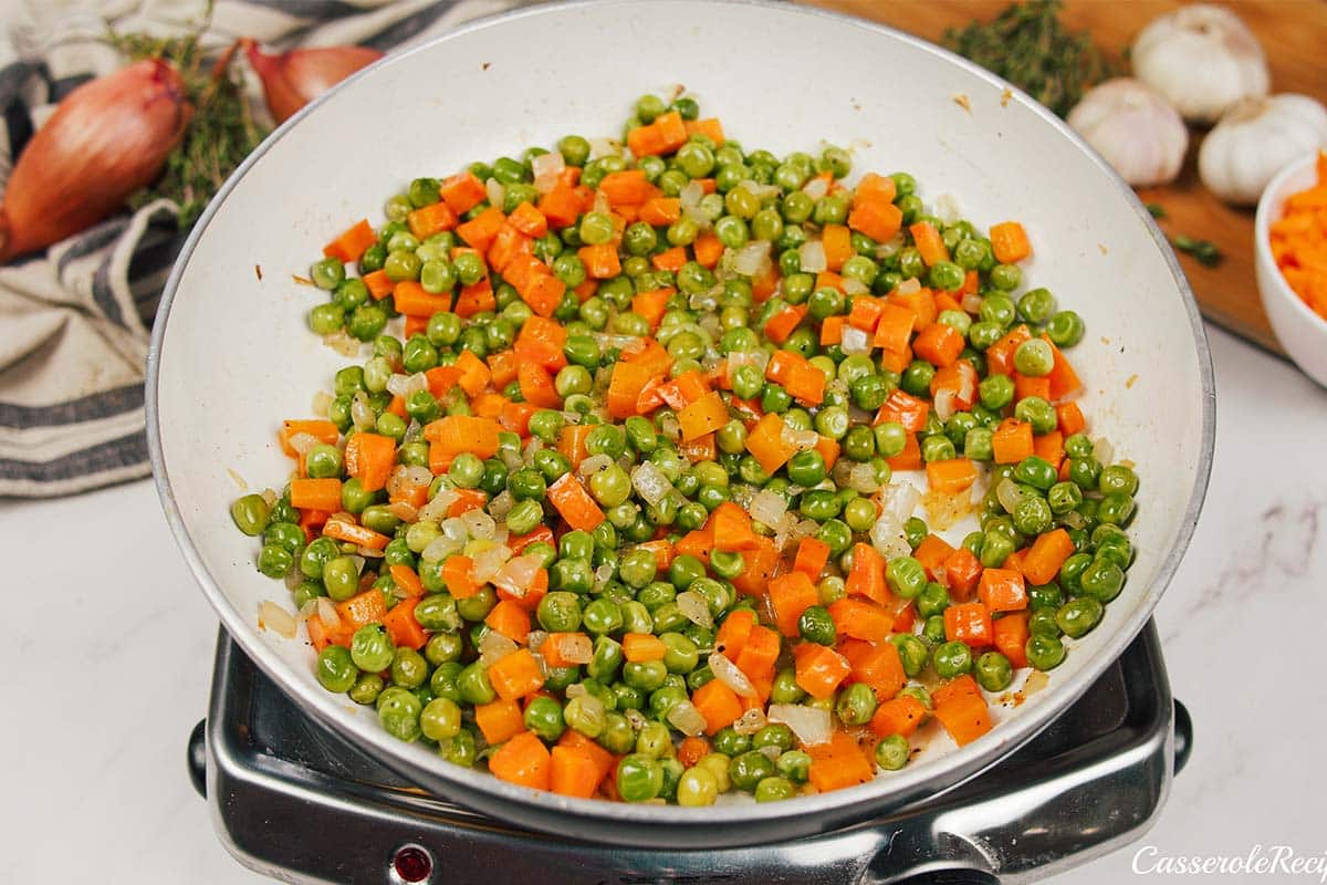 cooking vegetables to make chicken cobbler