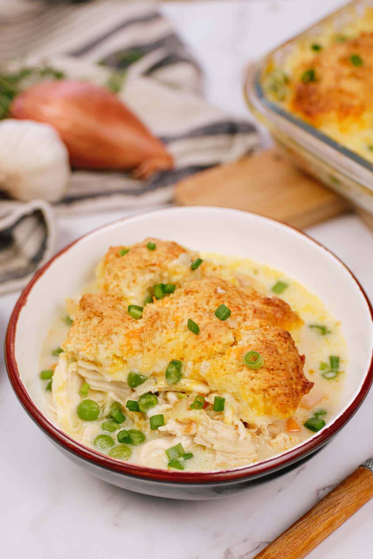 bowl full of chicken cobbler on a table