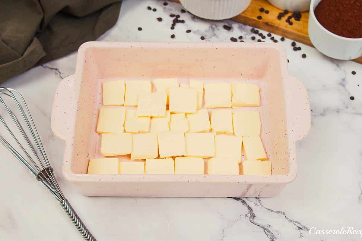 butter lining the bottom of a baking pan to make chocolate cobbler
