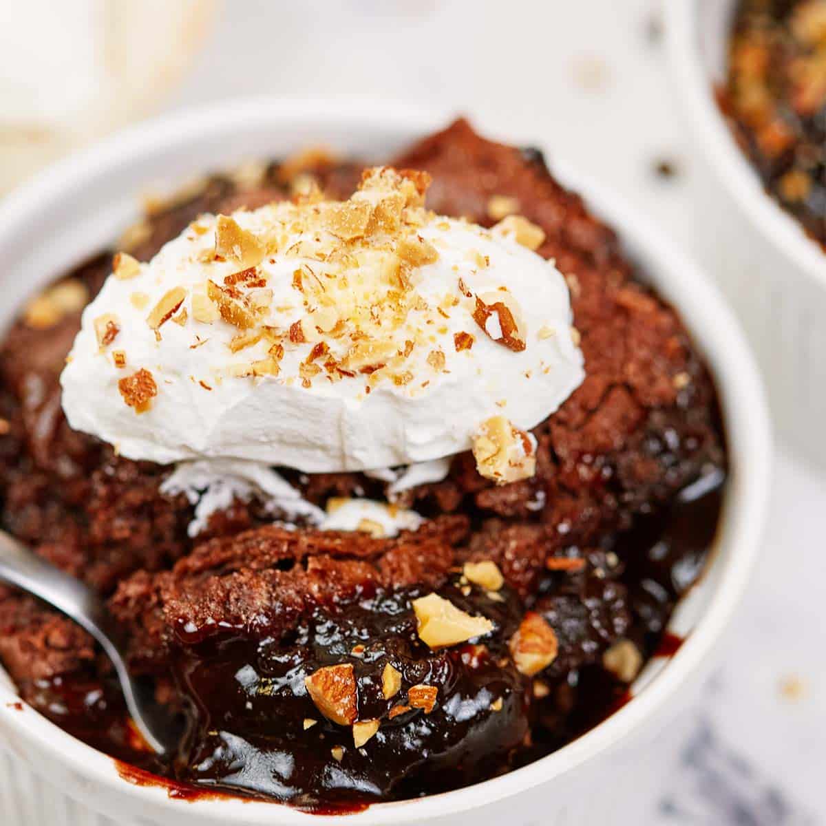 chocolate cobbler in a bowl with ice cream ready to enjoy
