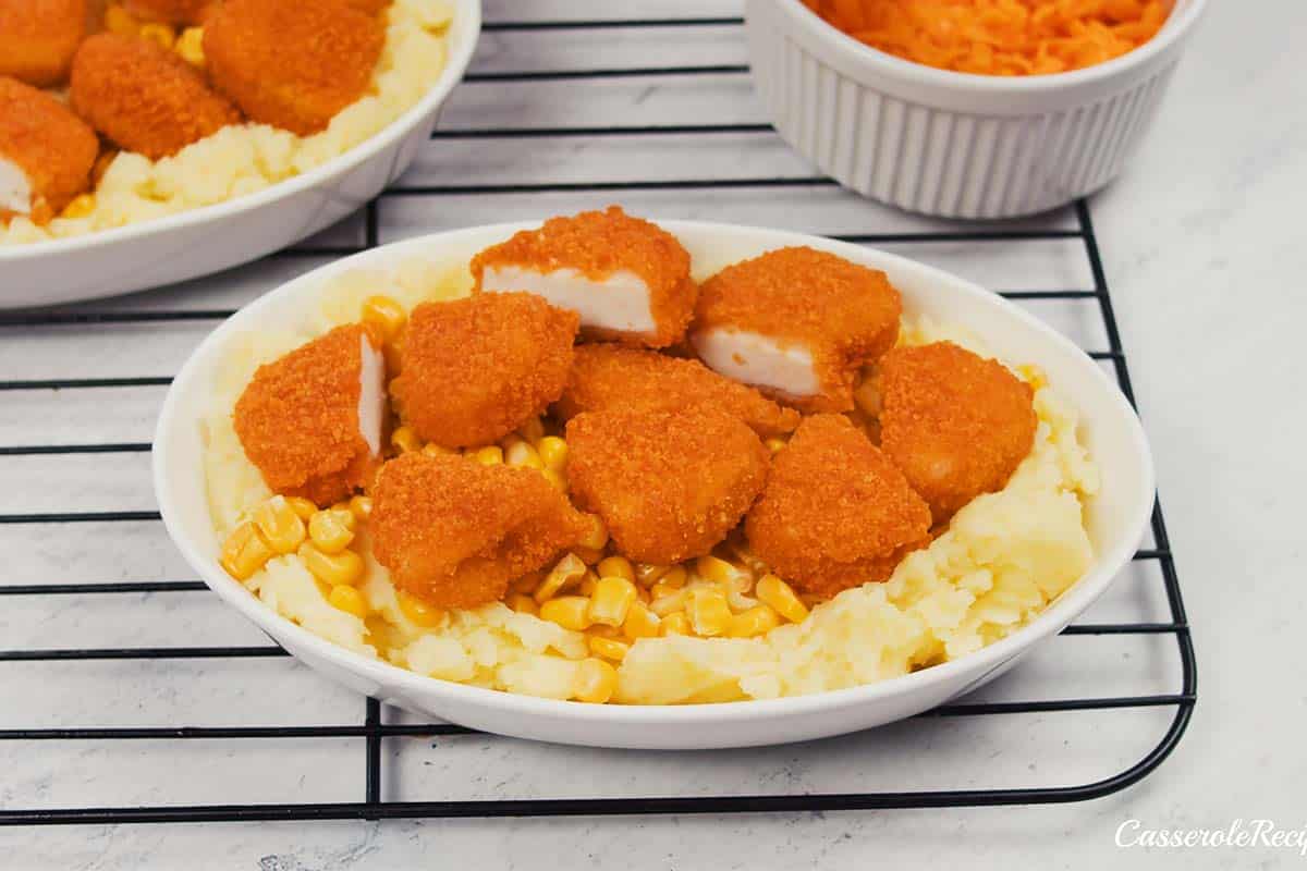 layering ingredients in a casserole dish to make copycat kfc famous bowl casserole