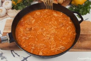 cream sauce with chicken being cooked to make creamy chicken casserole