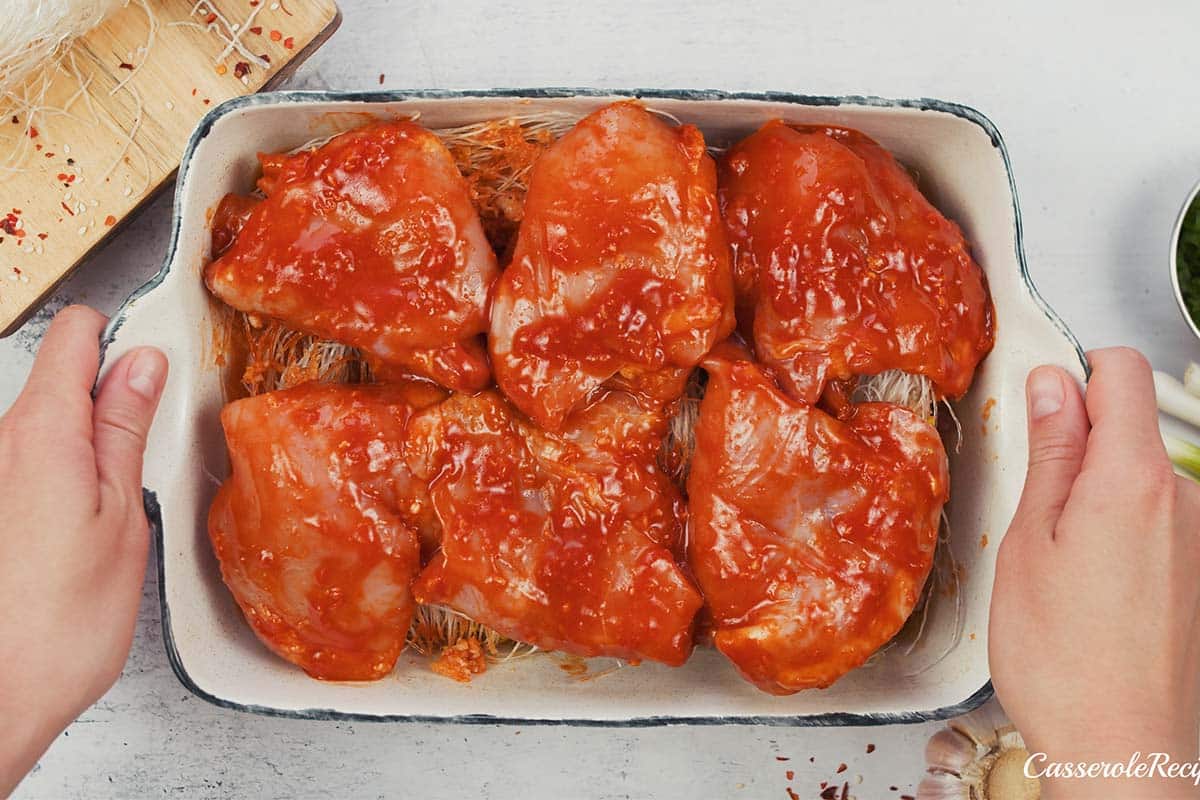 final step of making korean spicy chicken rice noodle bake in a baking dish