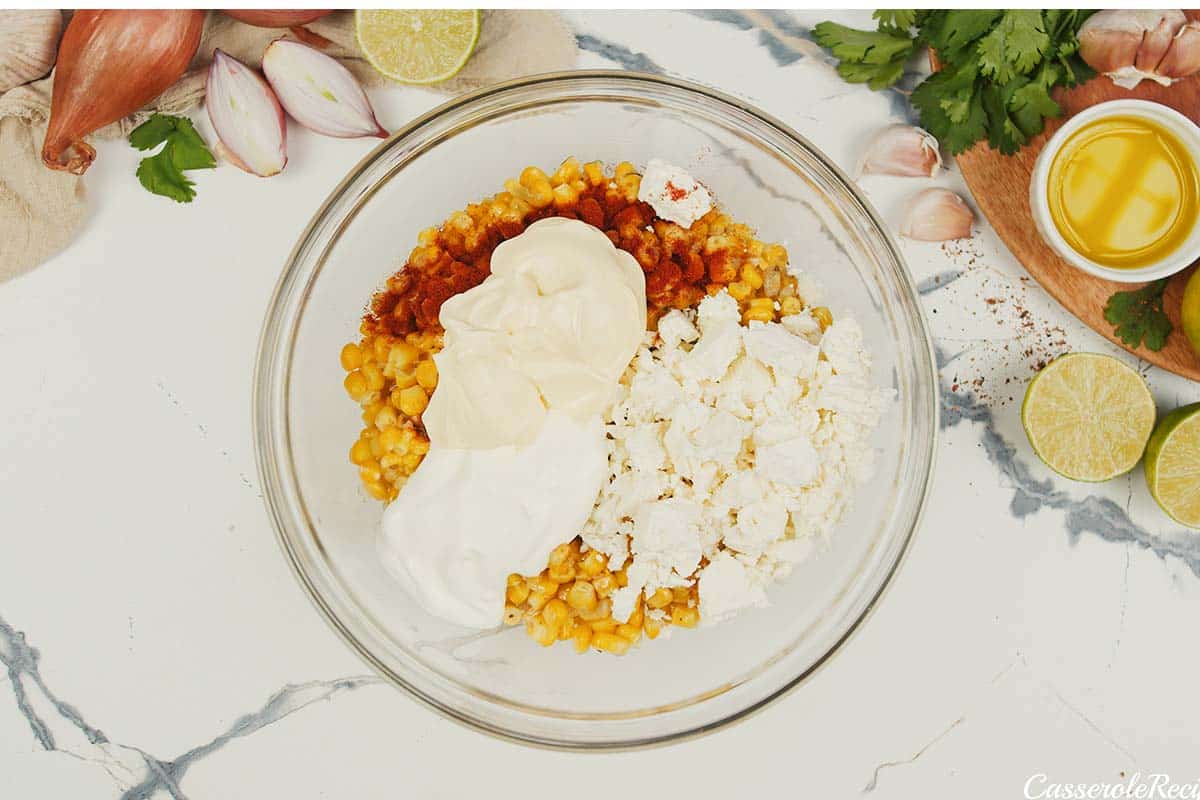 ingredients being combined to make mexican street corn casserole