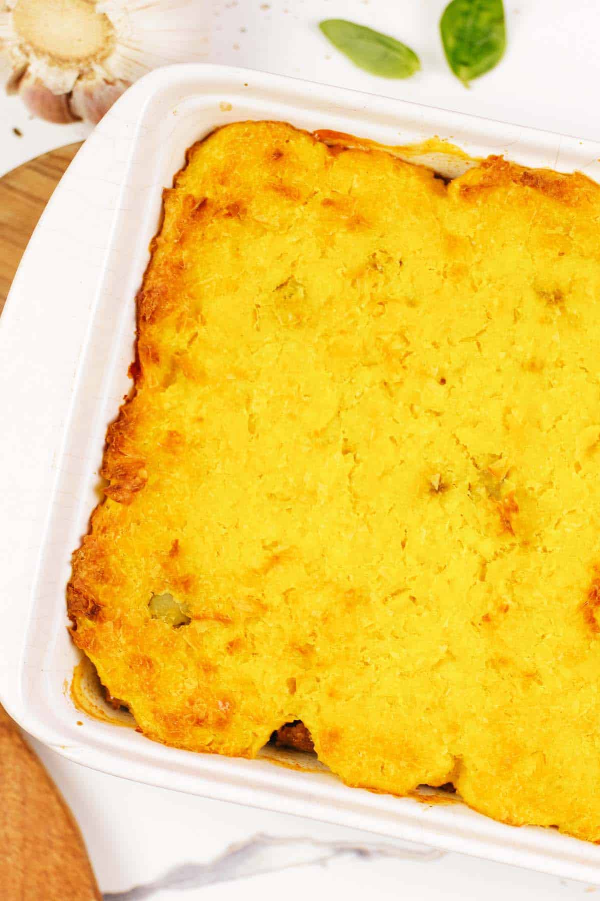 closeup of baking dish full of pastel de chocolo corn and beef casserole