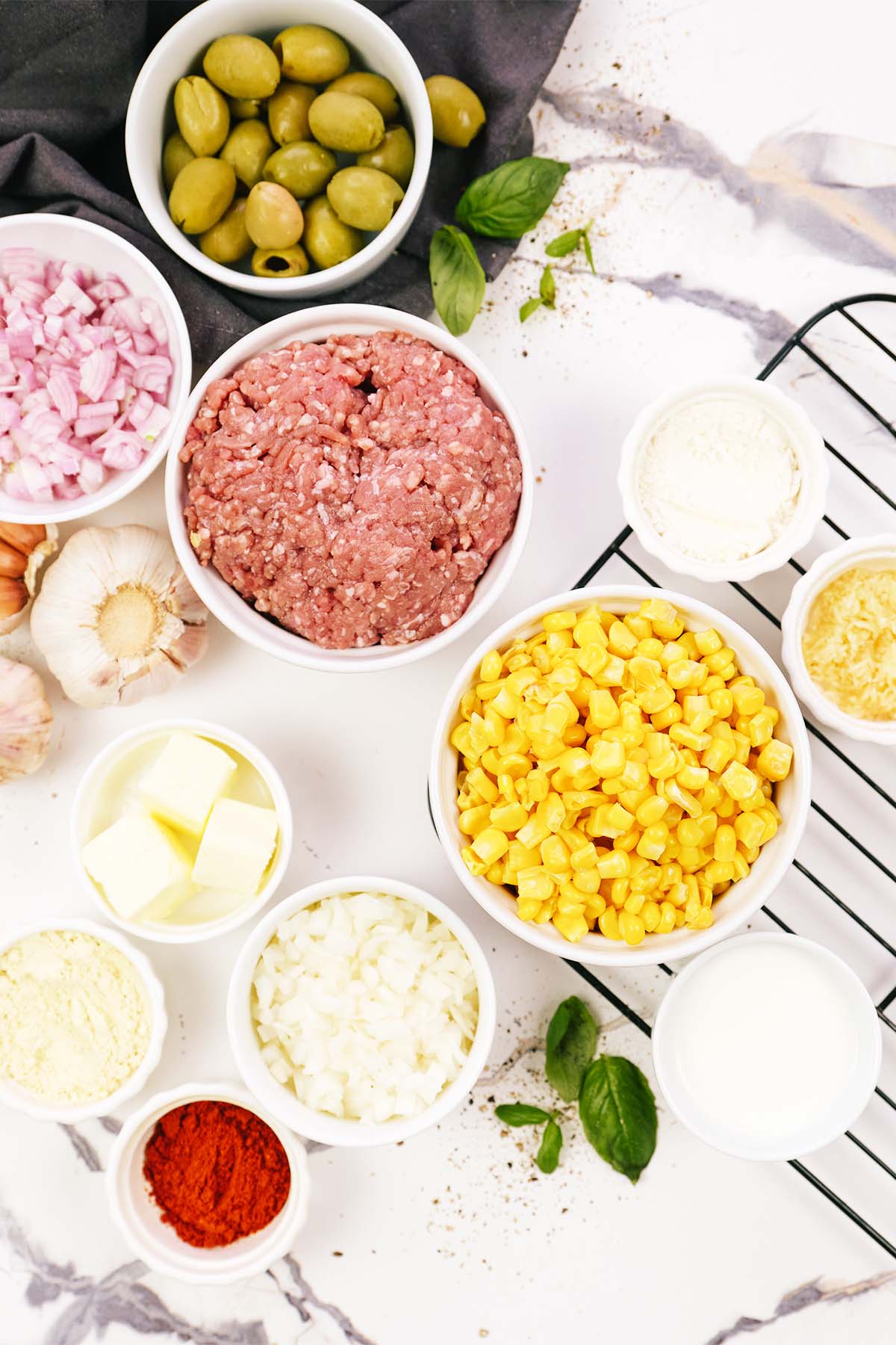 overhead view of ingredients to make pastel de chocolo corn and beef casserole on a table