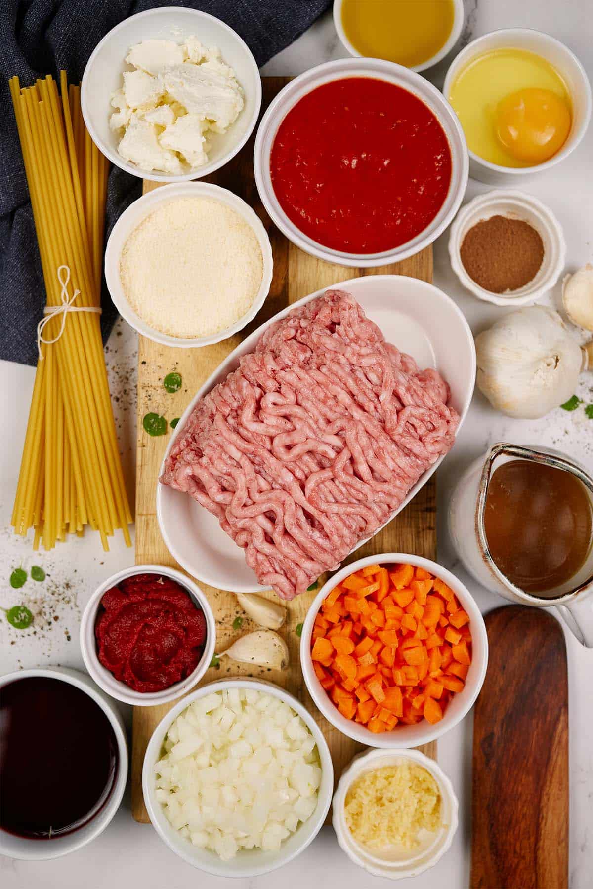 ingredients to make pastitsio greek beef pasta bake laid out on a table