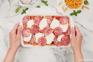 final step of adding toppings to pepperoni pasta bake prior to baking