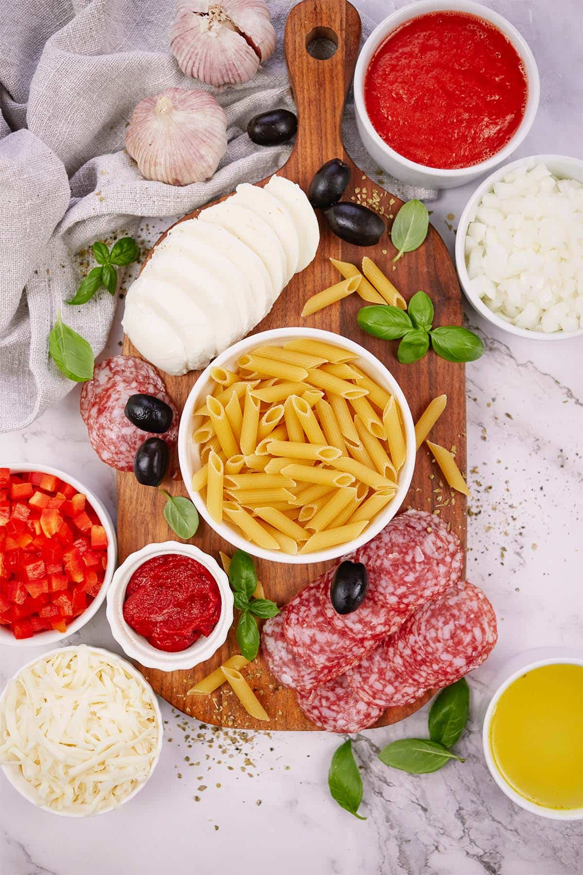 ingredients to make pepperoni pasta bake laid out on a table