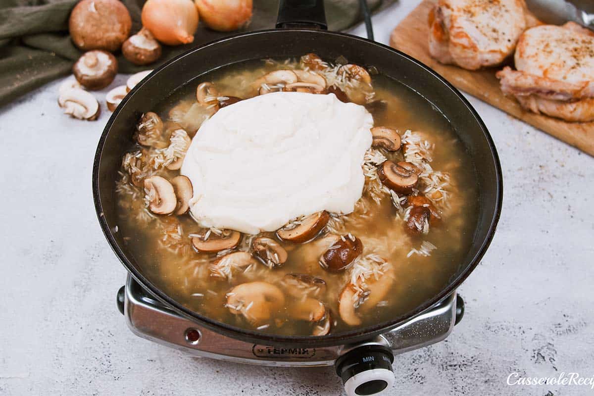 combining ingredients to make sauce for pork chops and rice casserole