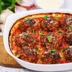 closeup of rissole, bacon and tomato casserole in a casserole dish ready to eat