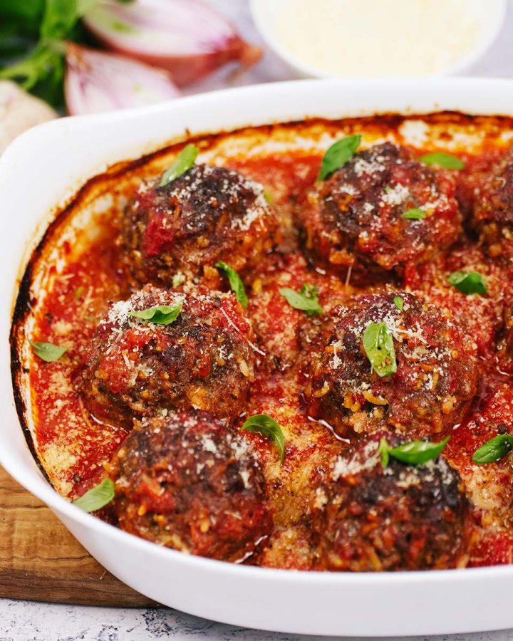 closeup of rissole, bacon and tomato casserole in a casserole dish ready to eat