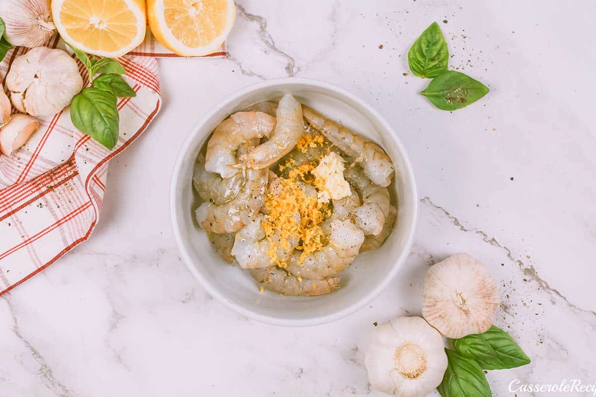 ingredients being combined to make shrimp and cauliflower bake