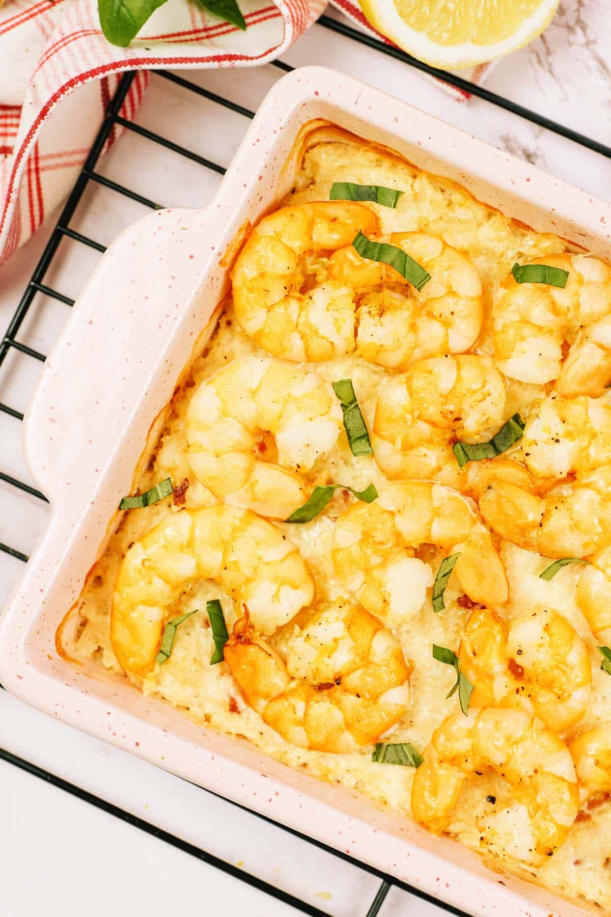 shrimp and cauliflower bake in a casserole dish resting on a wire rack