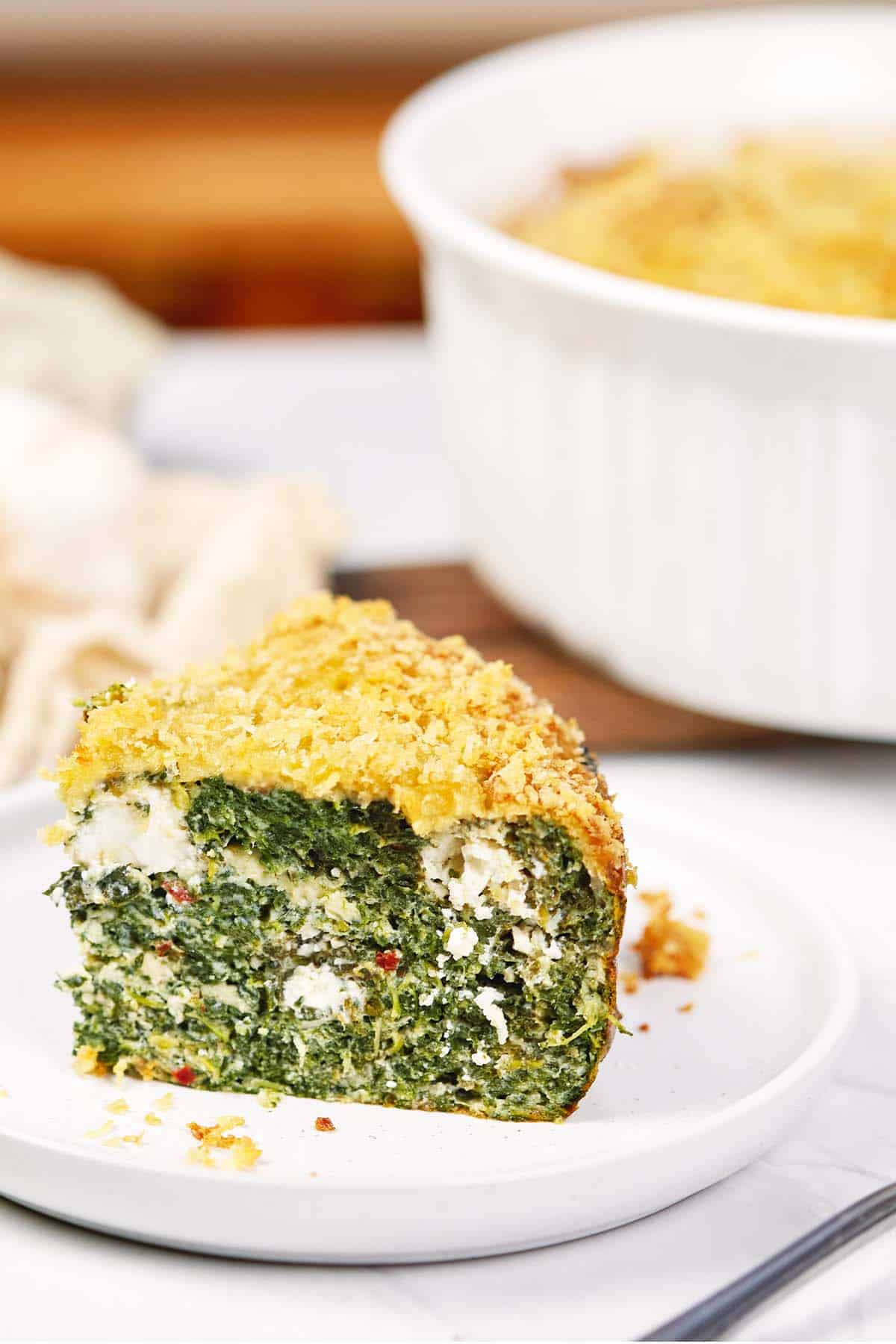 serving of spinach casserole with feta on a plate ready to enjoy