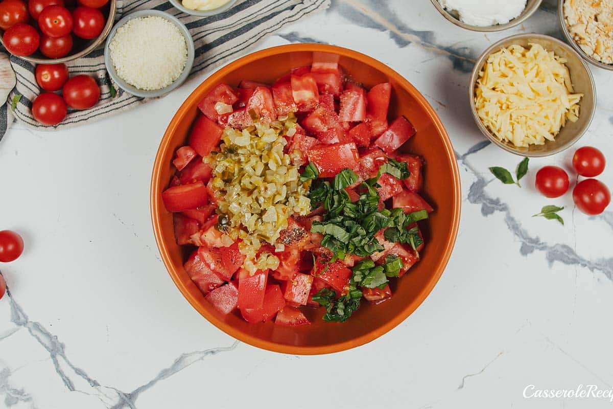 tomatoes and spices being combined to make tomato casserole