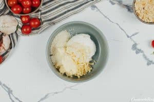 bowl of ingredients being mixed together to make topping for tomato casserole