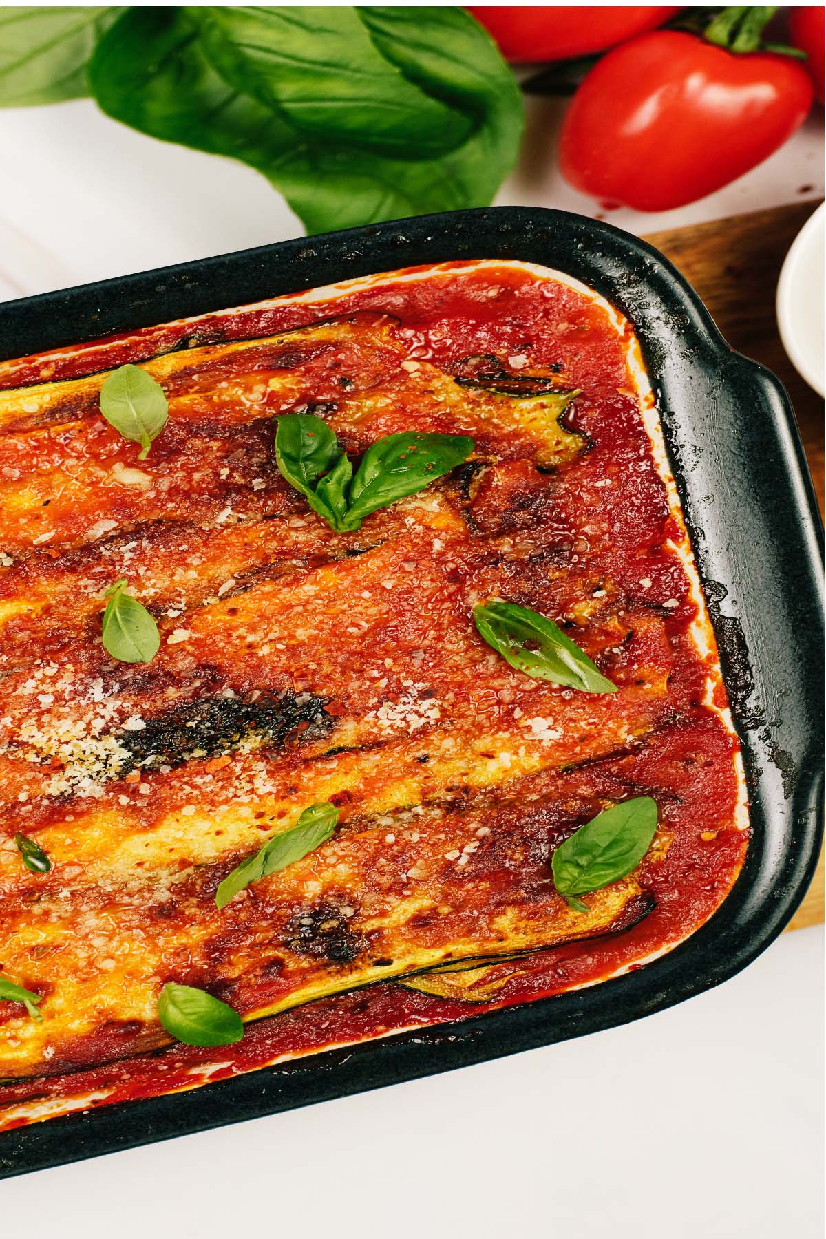 Zucchini Parmesan in a casserole dish on a table